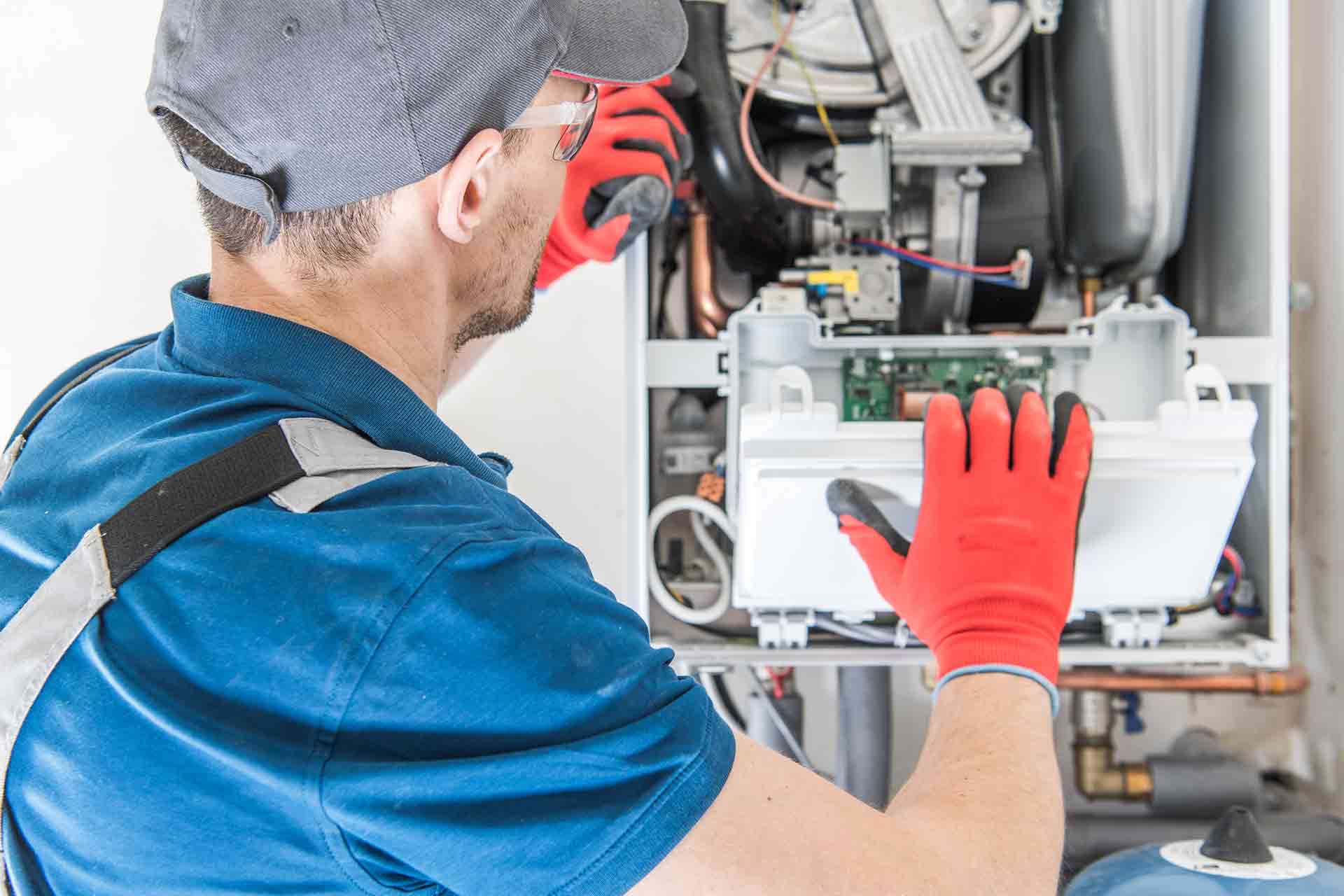 Dales Boiler Services Gas Safe engineer repairing a domestic gas boiler in Brighton